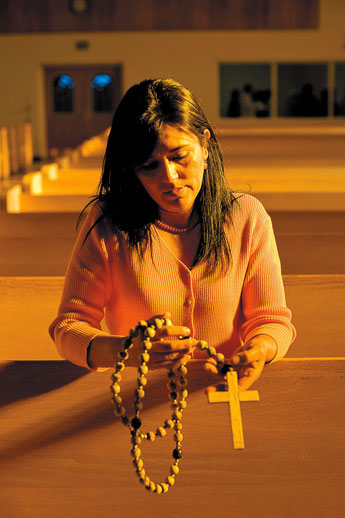 Maria Arreguin holds a rosary that was found in the boot-heel region of New Mexico, most likely left there by an immigrant crossing the U.S.-Mexico border. Arreguin, a legal immigrant, says she feels a strong connection to the rosary.  © 2011 Gallup Independent / Brian Leddy 